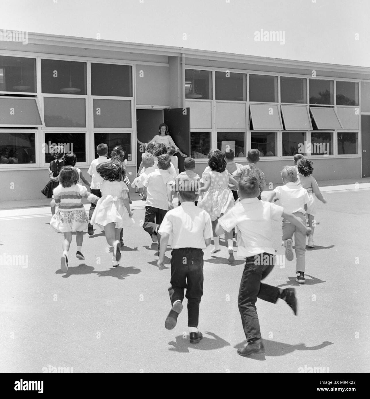Elementary students head for the school door and class in California, ca. 1965. Stock Photo