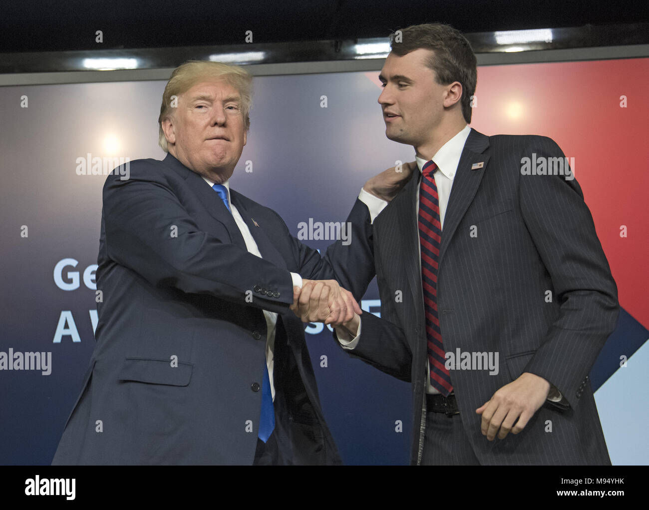 Washington, District of Columbia, USA. 22nd Mar, 2018. United States President Donald J. Trump, left, shakes hands with with Charlie Kirk, Founder and Executive Director of Turning Point USA, right, after participating in a panel discussion, at the Generation Next Summit at the White House in Washington, DC on Thursday, March 22, 2018.Credit: Ron Sachs/CNP Credit: Ron Sachs/CNP/ZUMA Wire/Alamy Live News Stock Photo