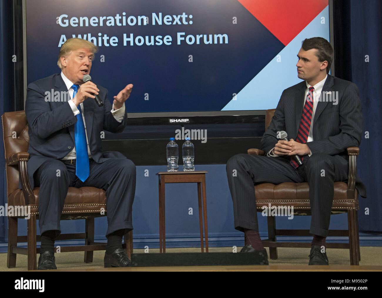 United States President Donald J. Trump, left, participates in a panel discussion with Charlie Kirk, Founder and Executive Director of Turning Point USA, right, at the Generation Next Summit at the White House in Washington, DC on Thursday, March 22, 2018. Credit: Ron Sachs/CNP /MediaPunch Stock Photo
