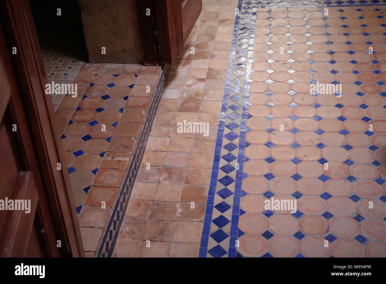 Decorative tiled flooring in a Moroccan Riad in tones of terracotta and blue Stock Photo