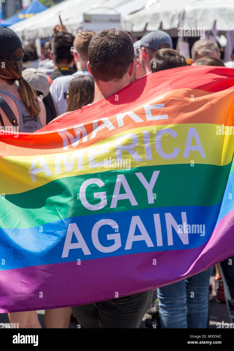 Washington DC - June 11, 2017. Capital Pride Parade, in Washington DC. Person holding a rainbow flag where one can read 'Make America gay again' Stock Photo