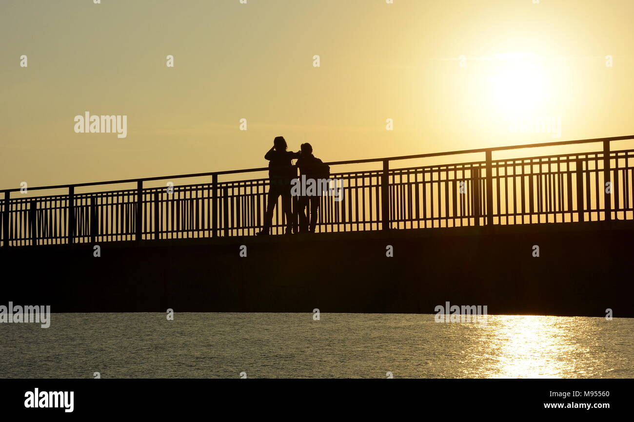 Silhouette of a couple on a bridge Stock Photo - Alamy