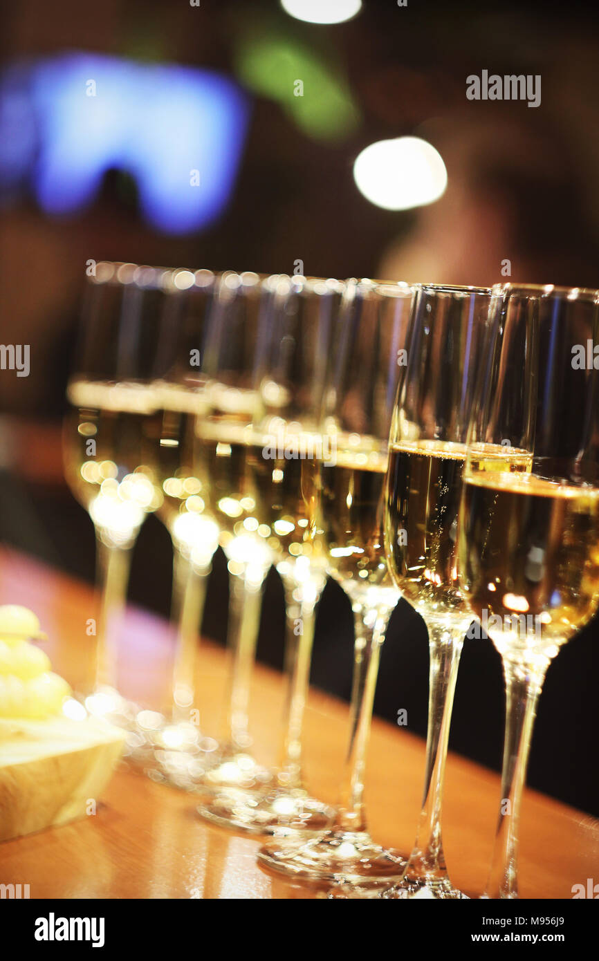 Sparkling wine glasses champagne stand in row at the bar, catering