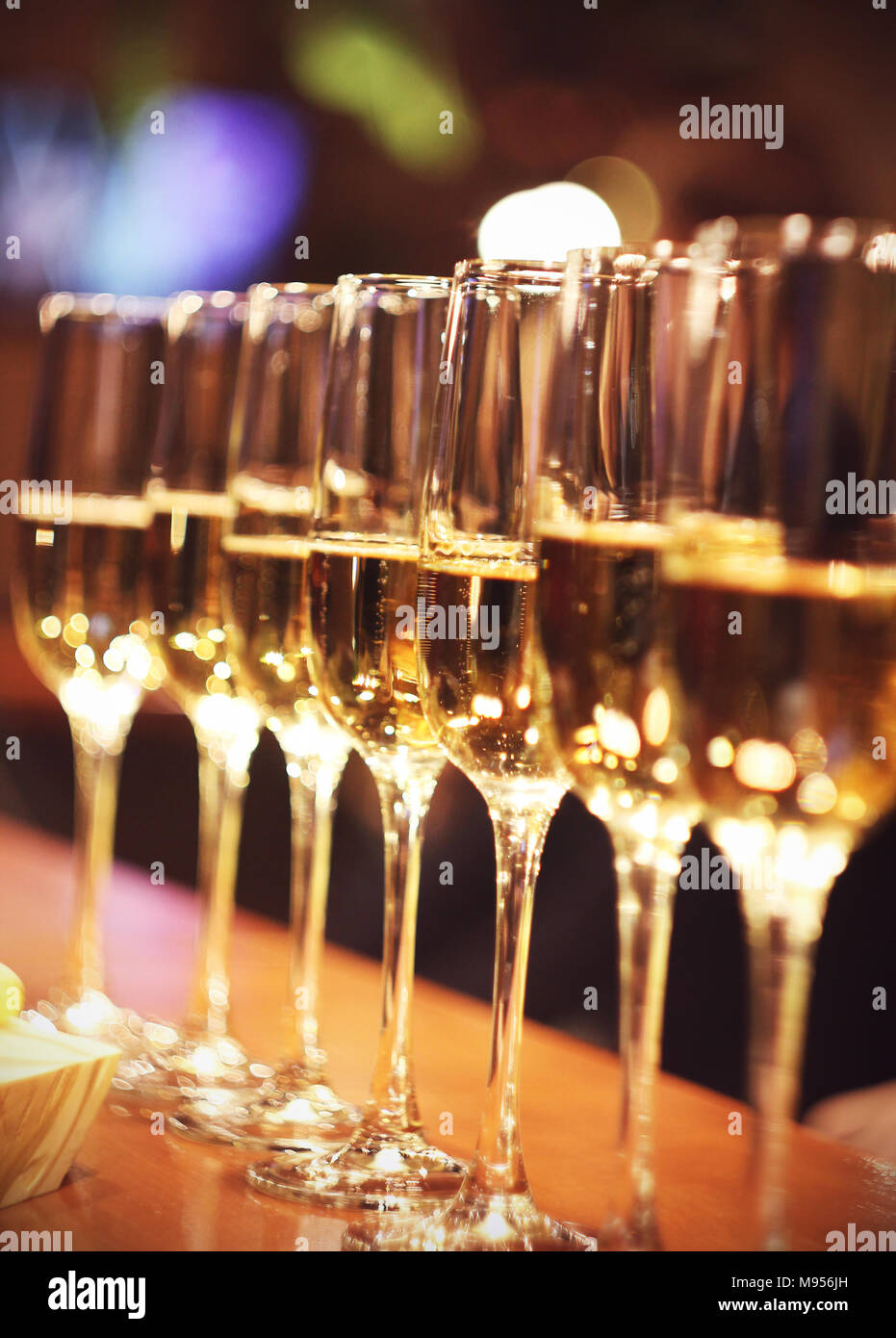 Sparkling wine glasses champagne stand in row at the bar, catering