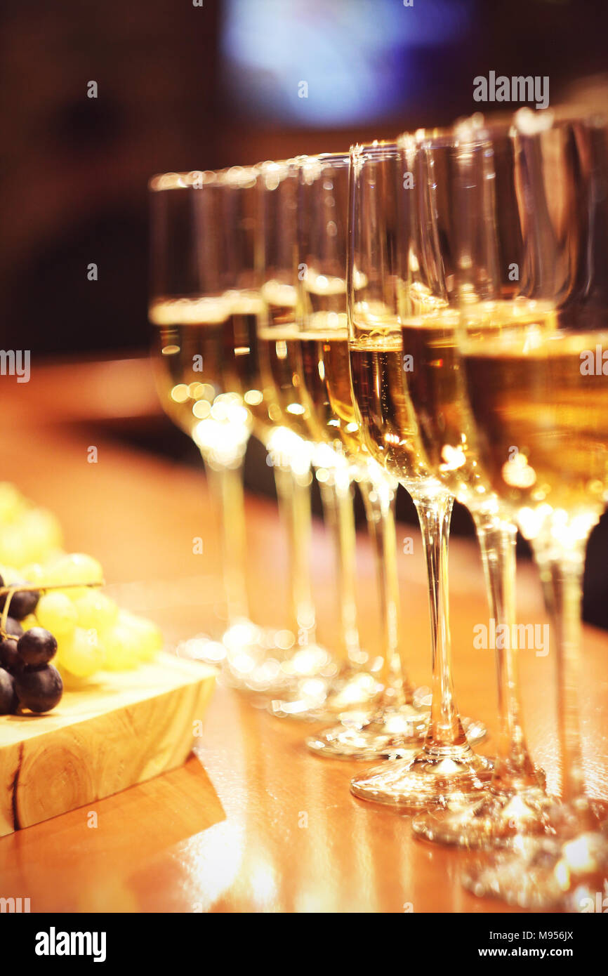 Sparkling wine glasses champagne stand in row at the bar, catering