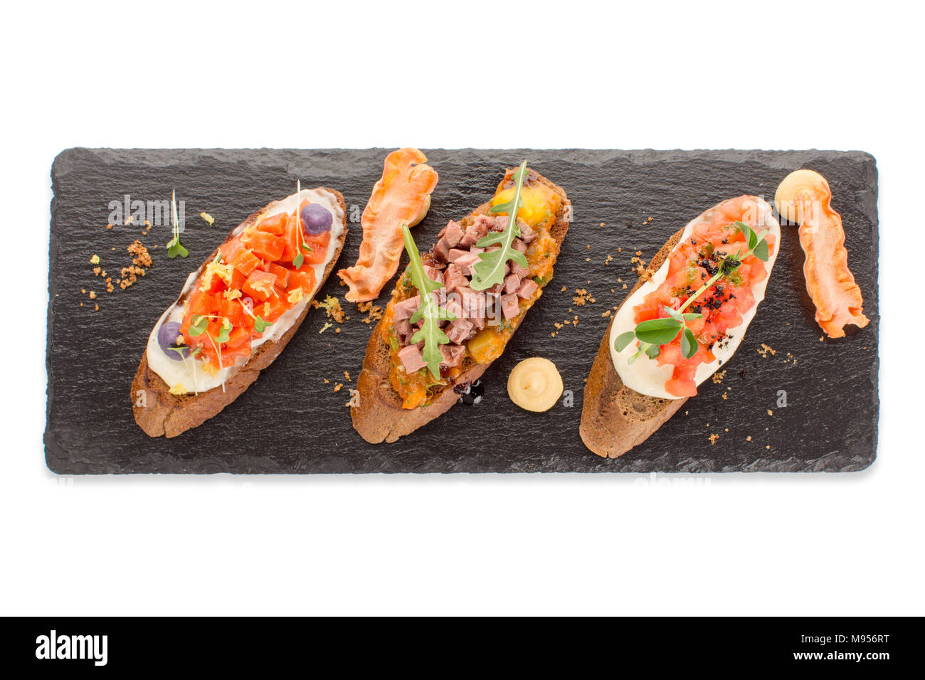 Three types of appetizers on an isolated board Stock Photo