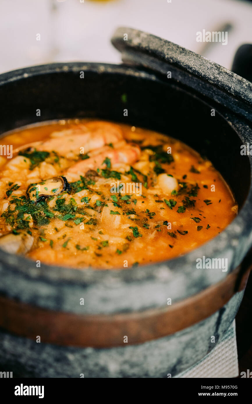 National cuisine of Cape Verde: Cachupa in traditional stone bowl. Stock Photo