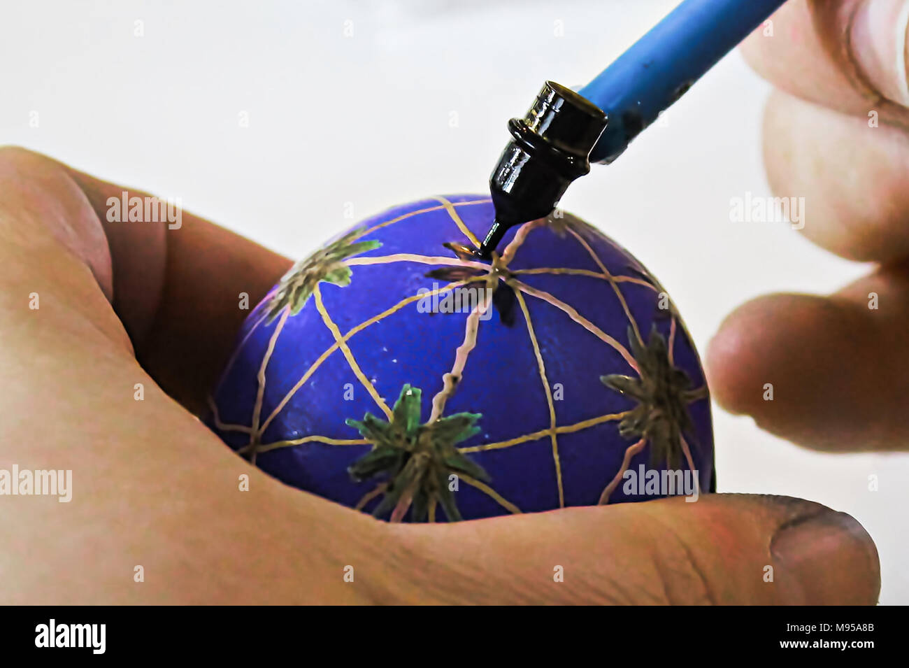 Decorating easter eggs with wax and a kistka. Stock Photo