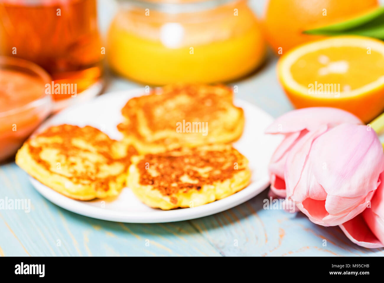 Cottage cheese cakes, honey, quince jam, flower Stock Photo Alamy