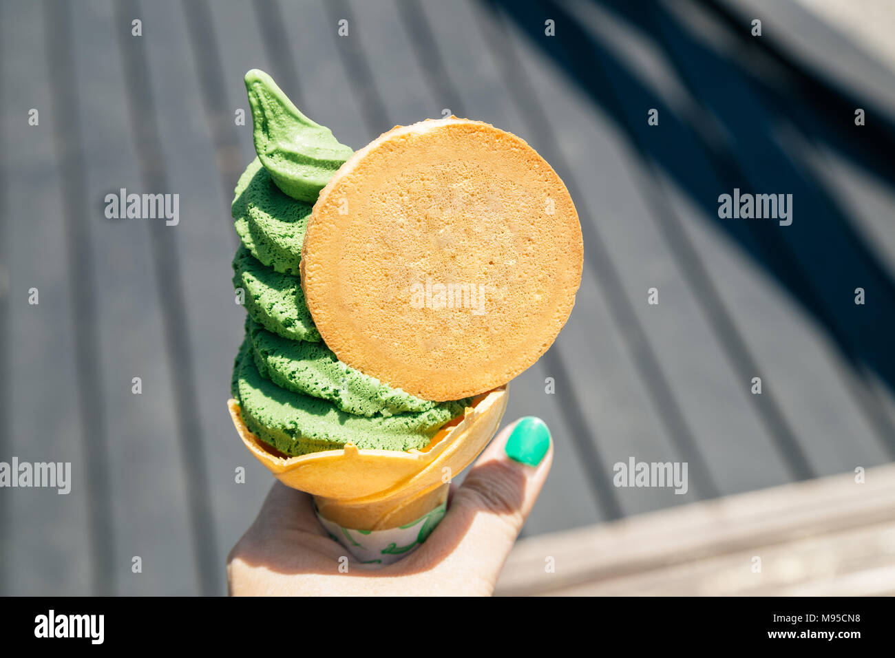 Holding green tea soft ice cream cone in Yufuin, Japan Stock Photo
