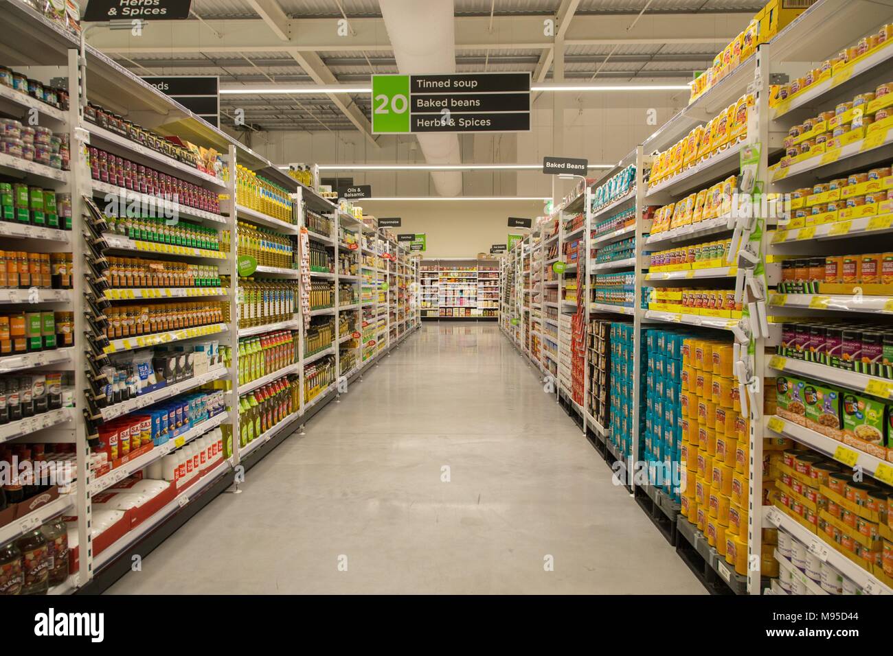 Tinned soup,baked beans,herbs and spices on full shelves in an Asda supermarket. Stock Photo