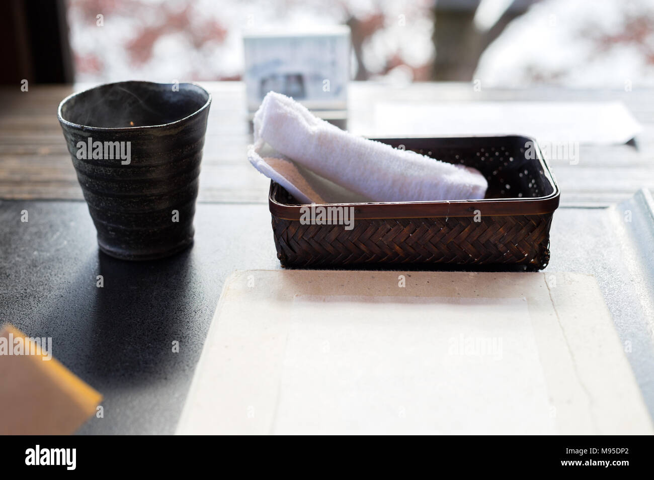 Japanese Restaurant, Cup and wet towel - shallow depth Stock Photo