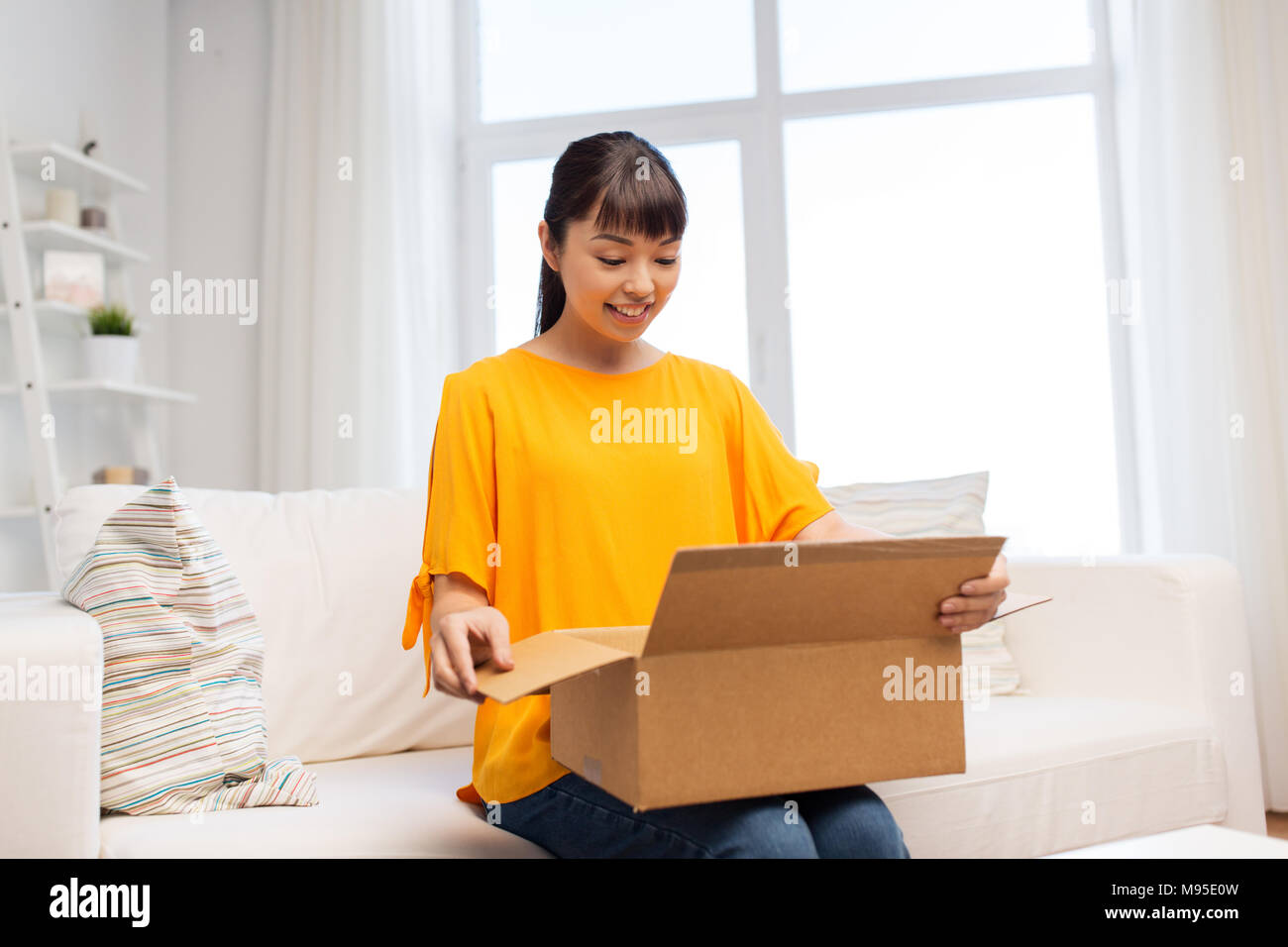happy asian young woman with parcel box at home Stock Photo - Alamy