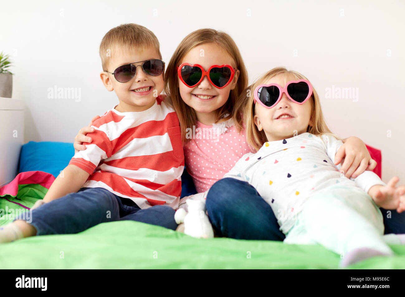 happy little kids in sunglasses at home Stock Photo