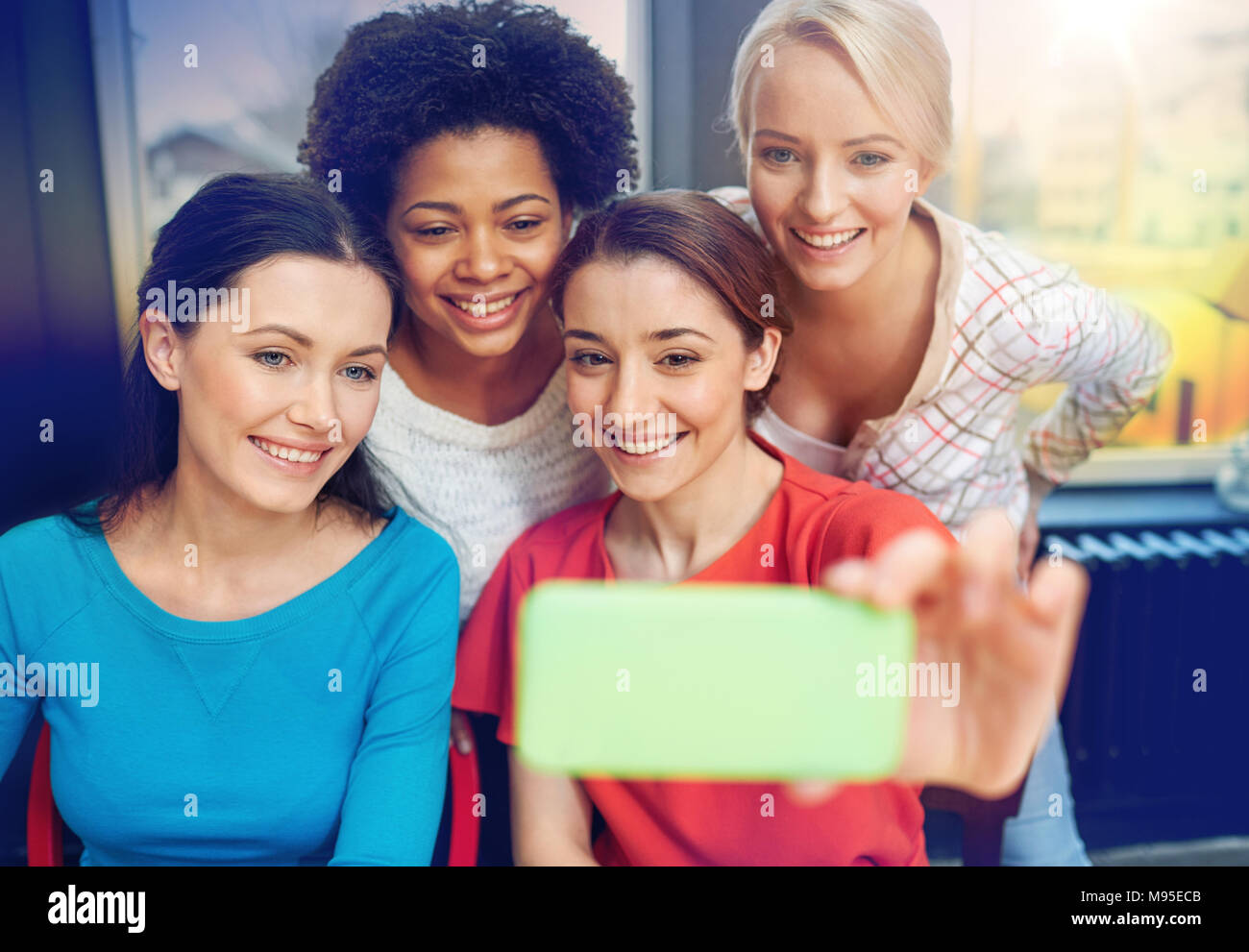 happy young women taking selfie with smartphone Stock Photo - Alamy