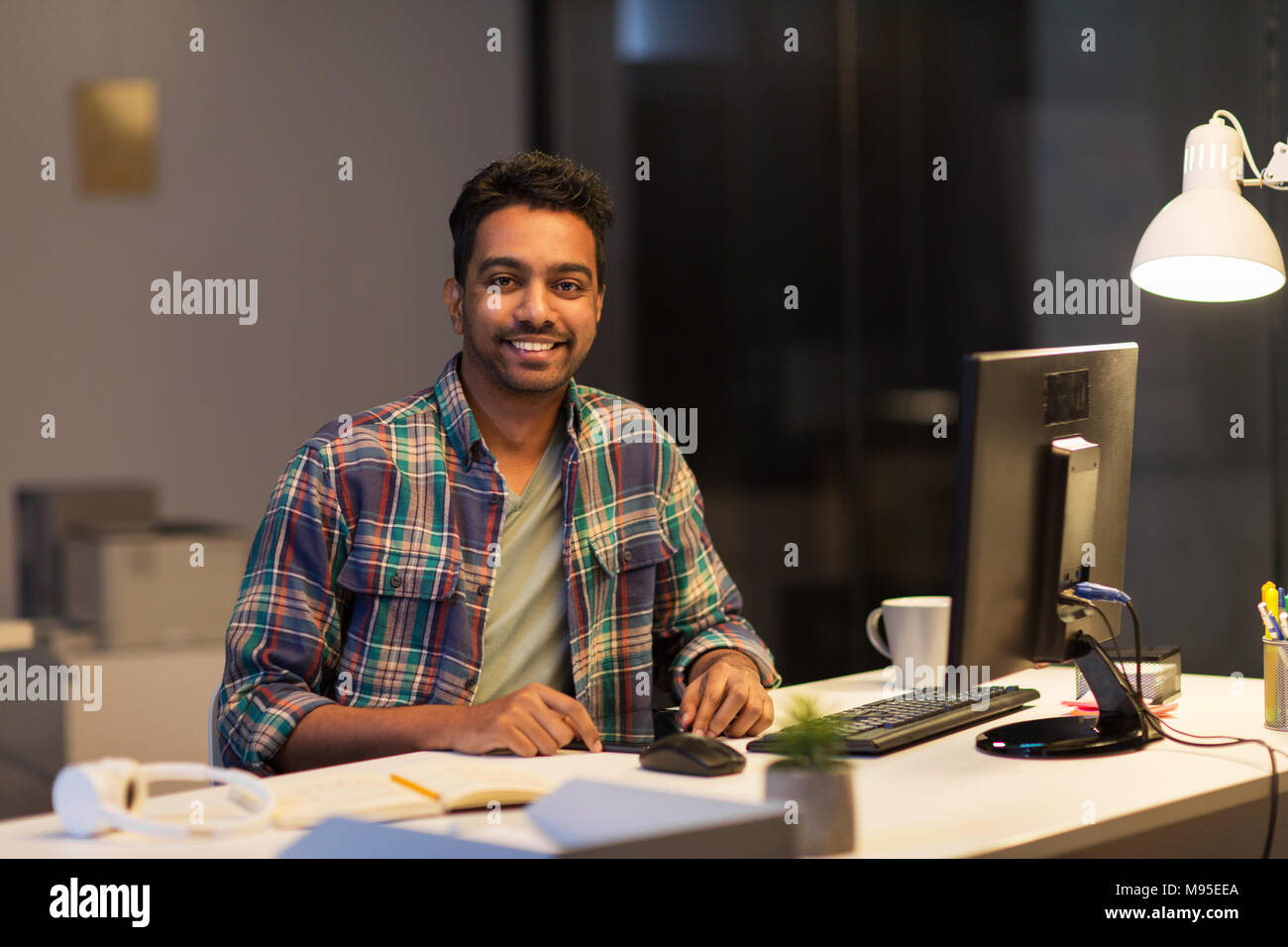 creative man with tablet pc at night office Stock Photo