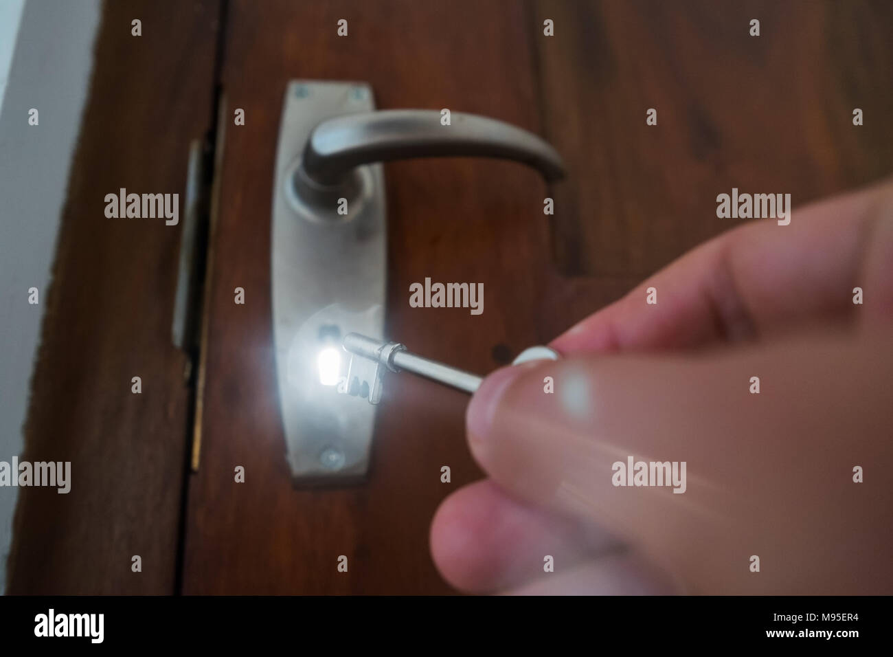 Man Hand Opening Door With Key Light Is Going Out Of Door Hole