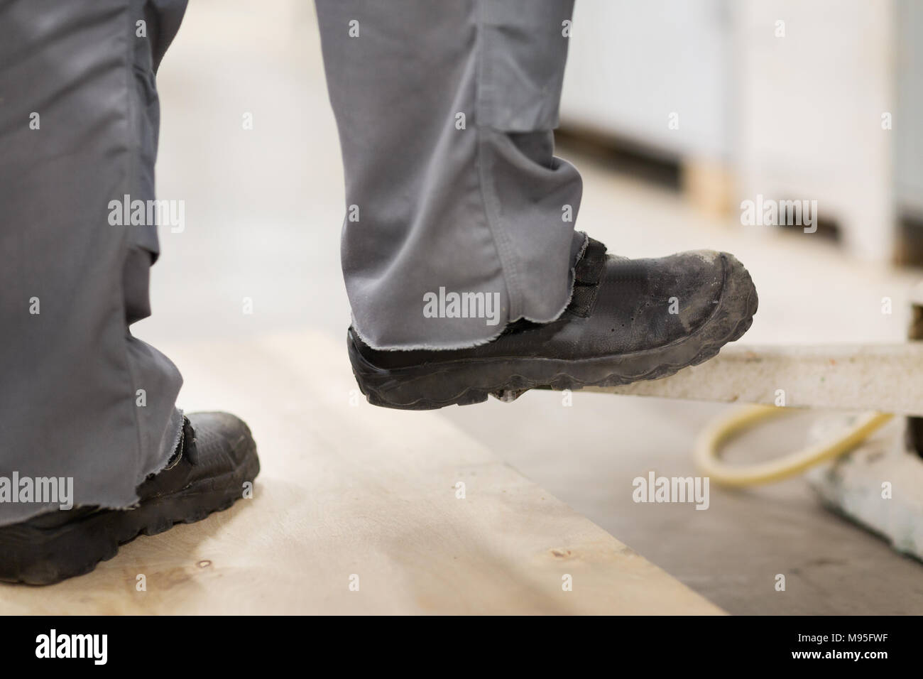 close up of male worker feet in working shoes Stock Photo