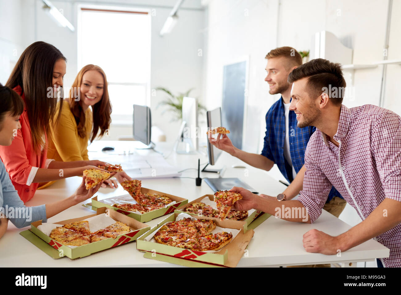 Happy Business Team Eating Pizza At Office Stock Photo Alamy
