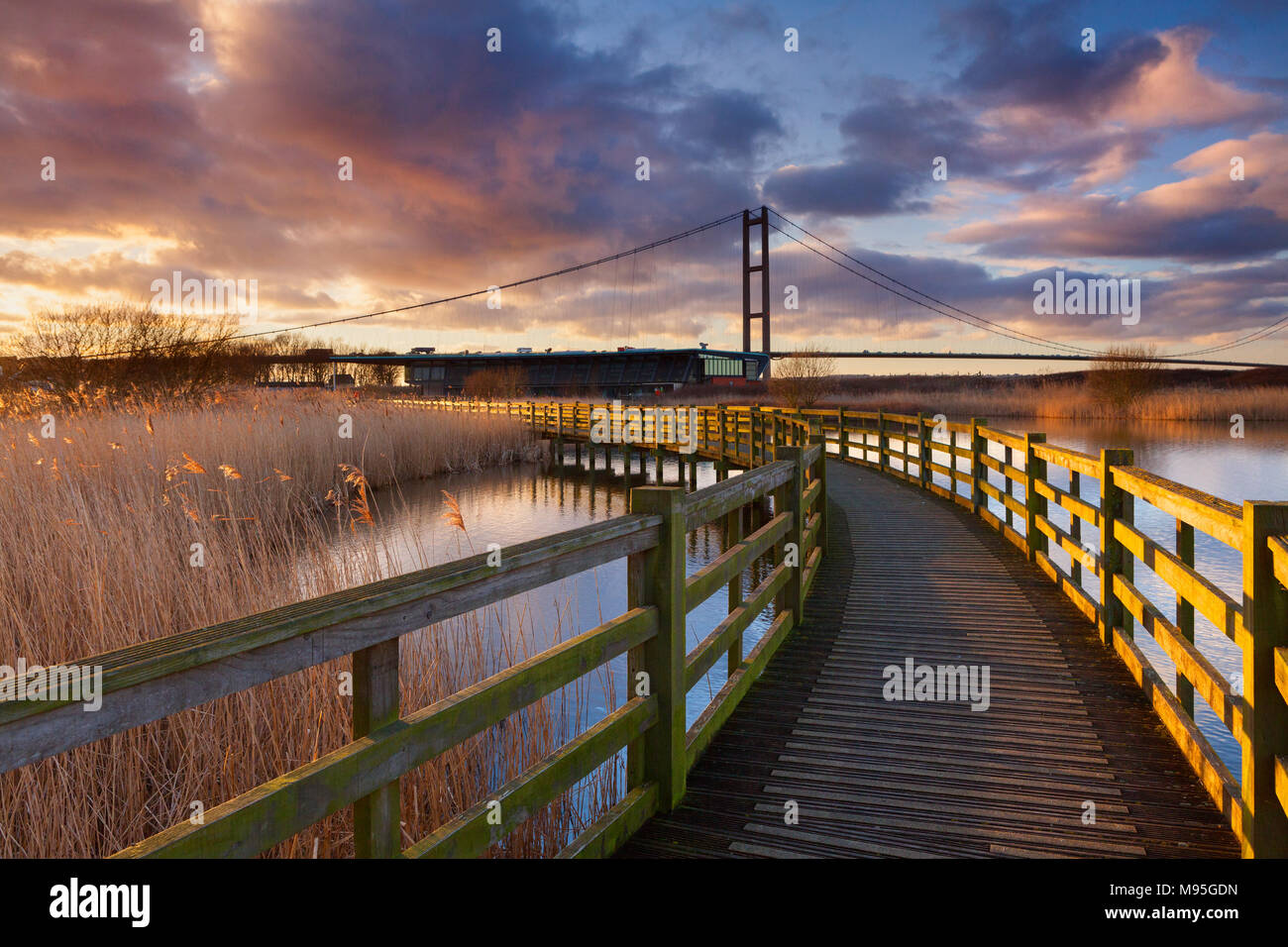 The Water's Edge Country Park in Barton-upon-Humber, North Lincolnshire, UK. The Humber Bridge towers over the park's Visitor Centre. Stock Photo