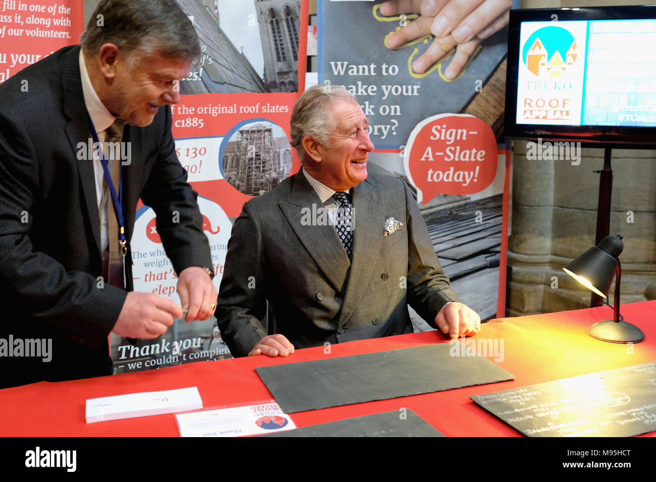 The Prince of Wales signs a slate in support of the Roof Appeal during his visit to Truro Cathedral, in Cornwall, to meet community groups and businesses utilising the newly refurbished Old Cathedral School. Stock Photo