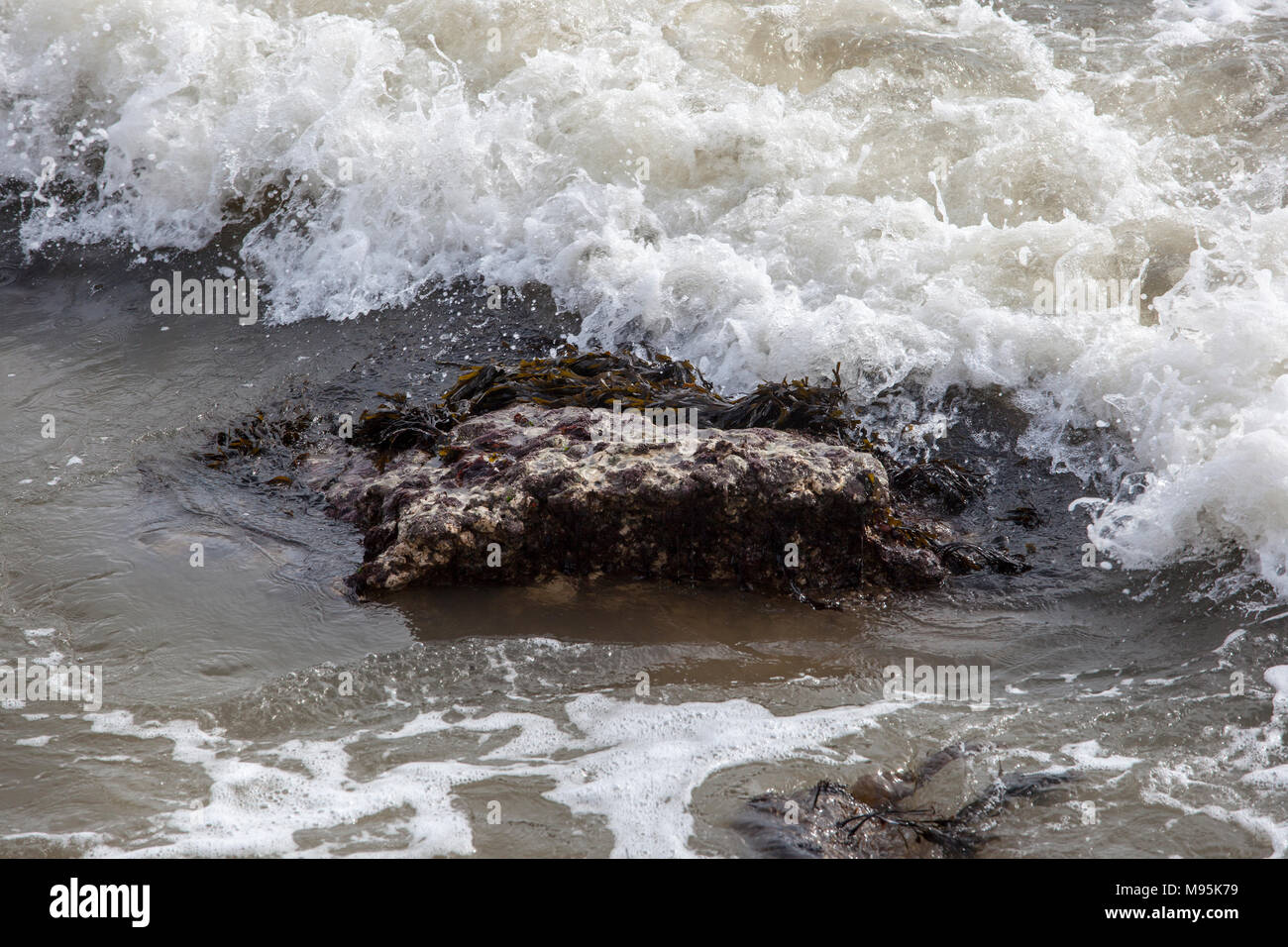 waves breaking on rocks Stock Photo