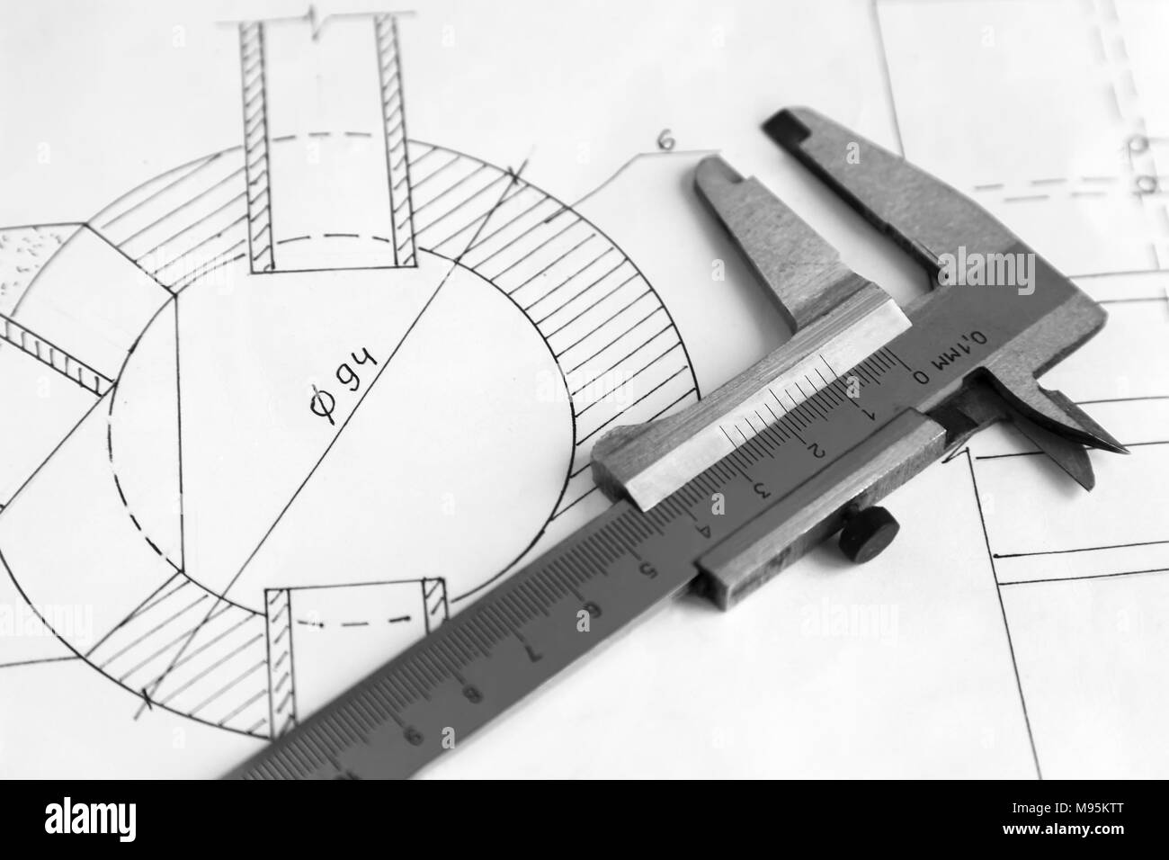 On the detail drawing lies measuring tool Vernier caliper. Black and white image. Stock Photo