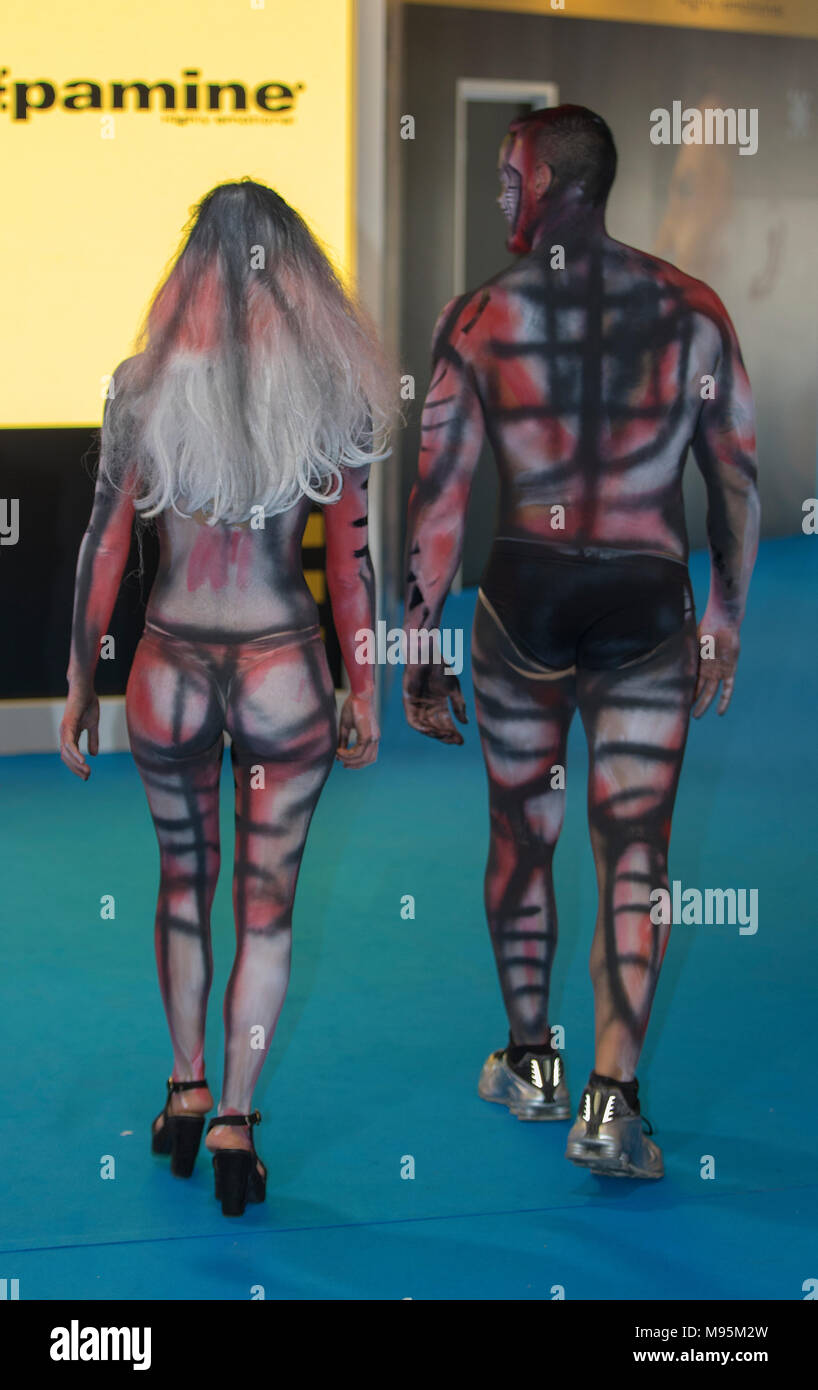Performing body painting on women and man Stock Photo