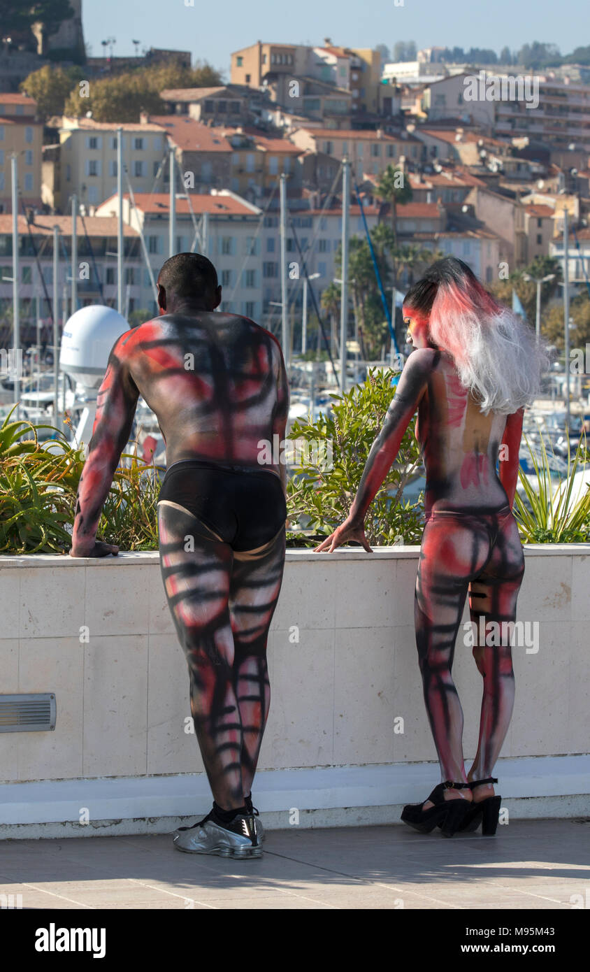 Performing body painting on women and man Stock Photo