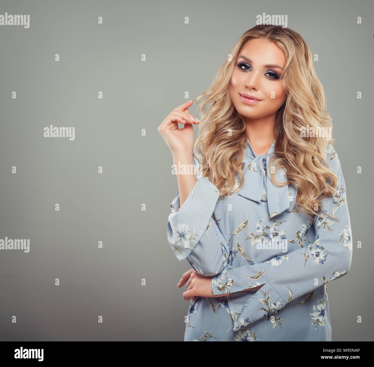 Confident Young Woman Standing on Gray Background with Copy space Stock Photo