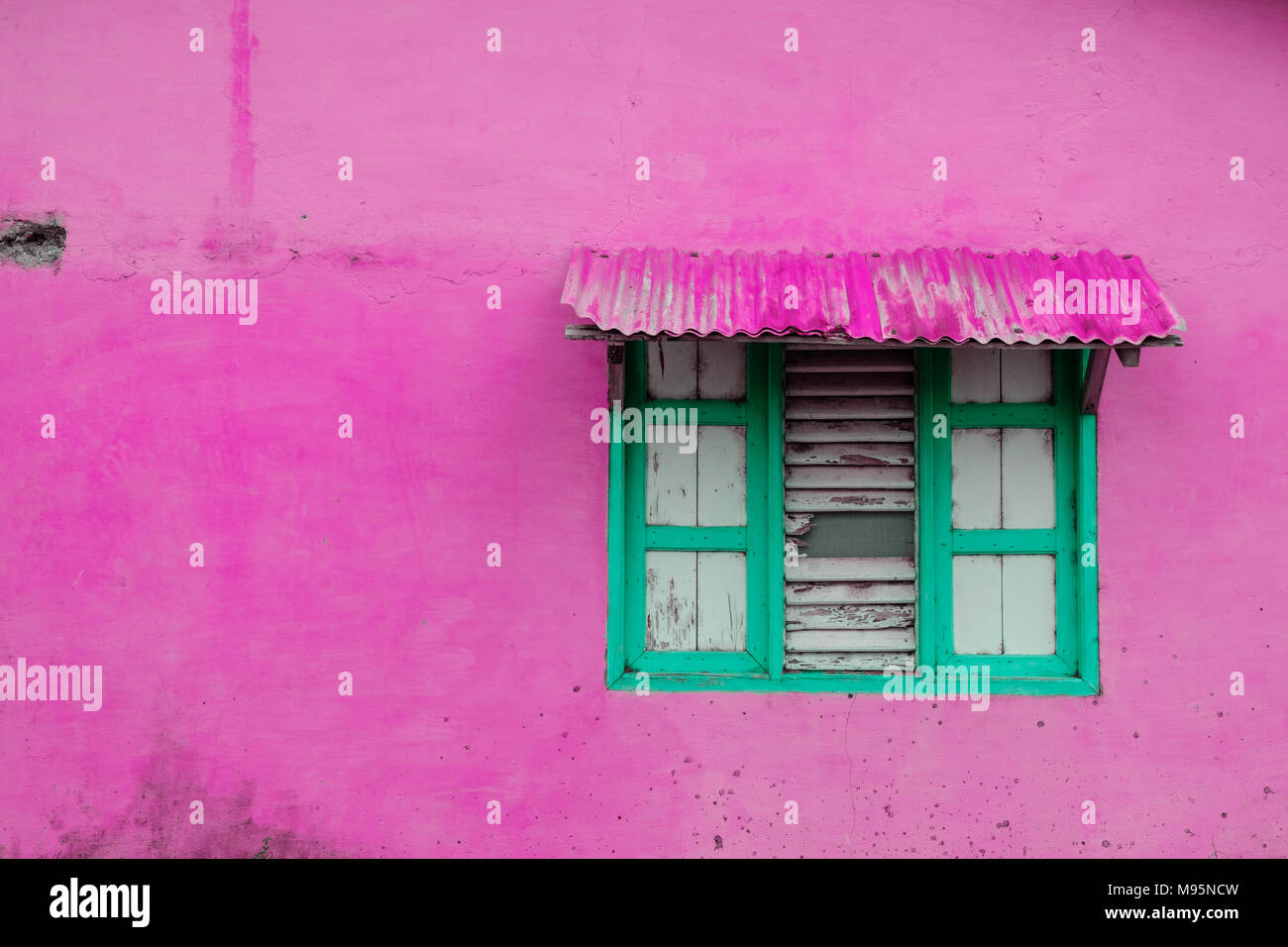 pink building exterior, vintage wall  with closed window and wooden shutter - Stock Photo