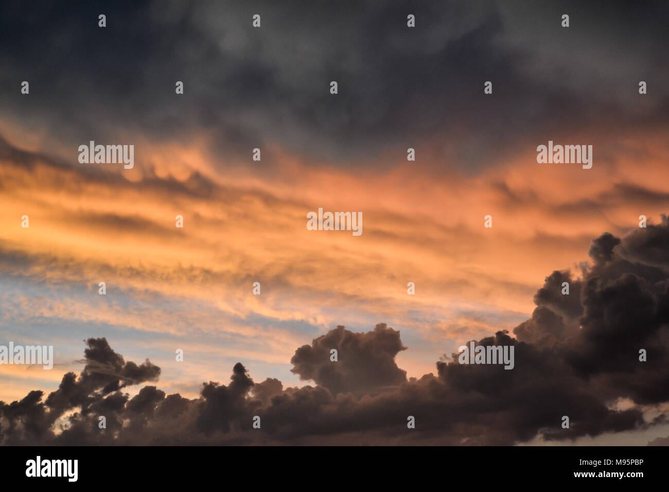 The sky lit up with the setting sun Stock Photo Alamy