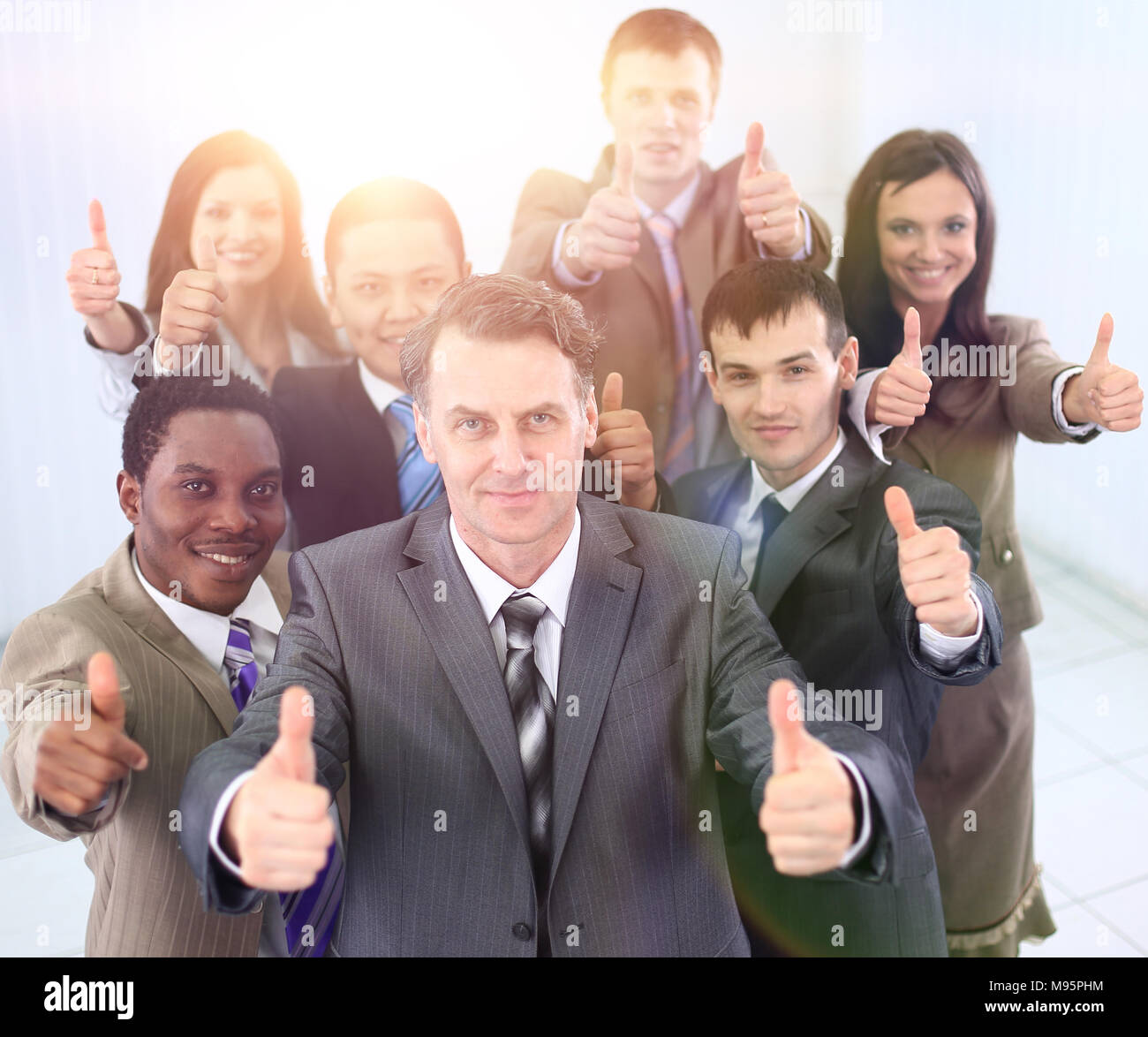 happy business team holding thumbs up Stock Photo - Alamy