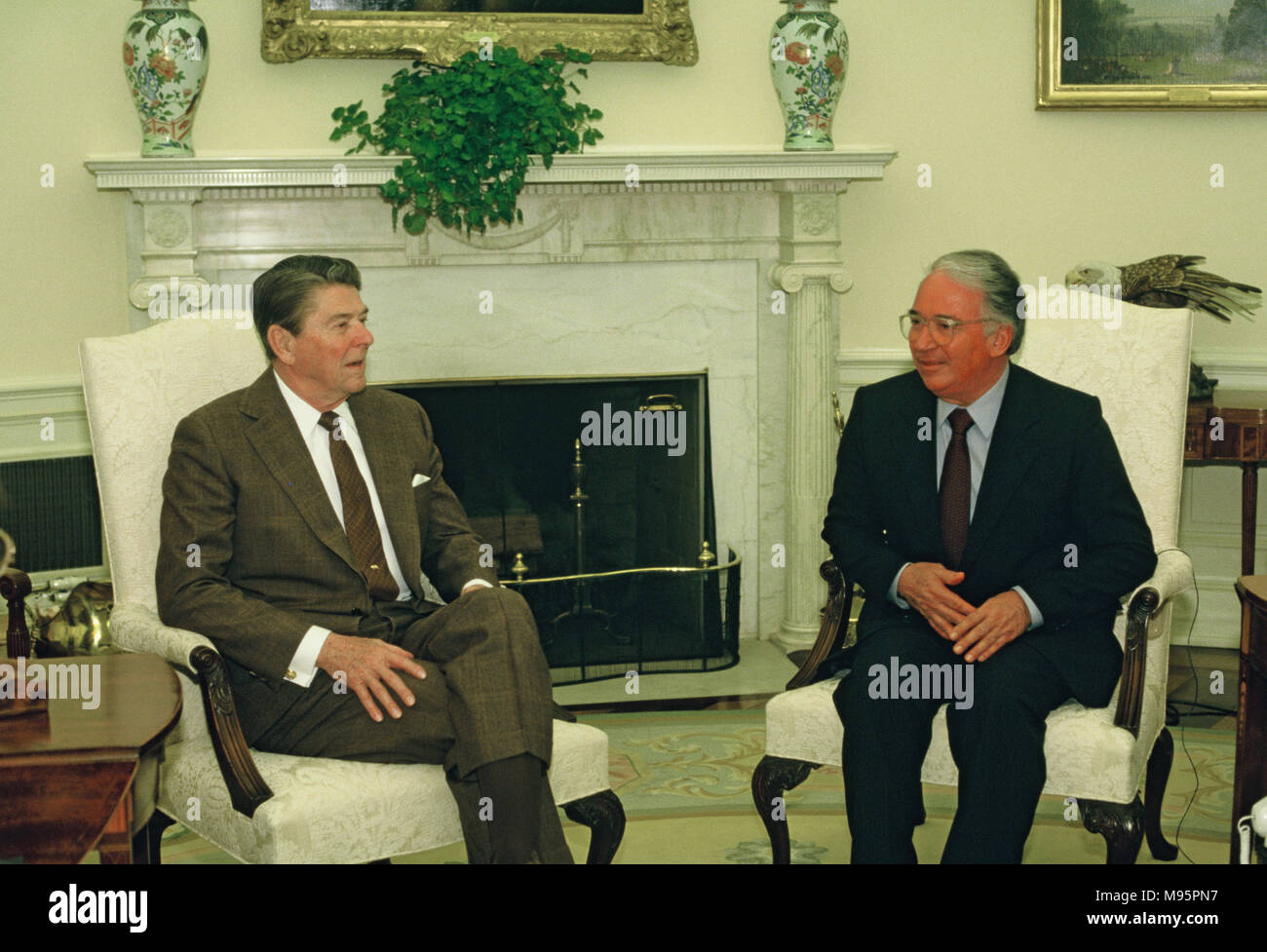 President Ronald Reagan meeting with President  Belisario  Betancur, Columbia in the Oval Office on April 4, 1985 Photograph by Dennis Brack Stock Photo