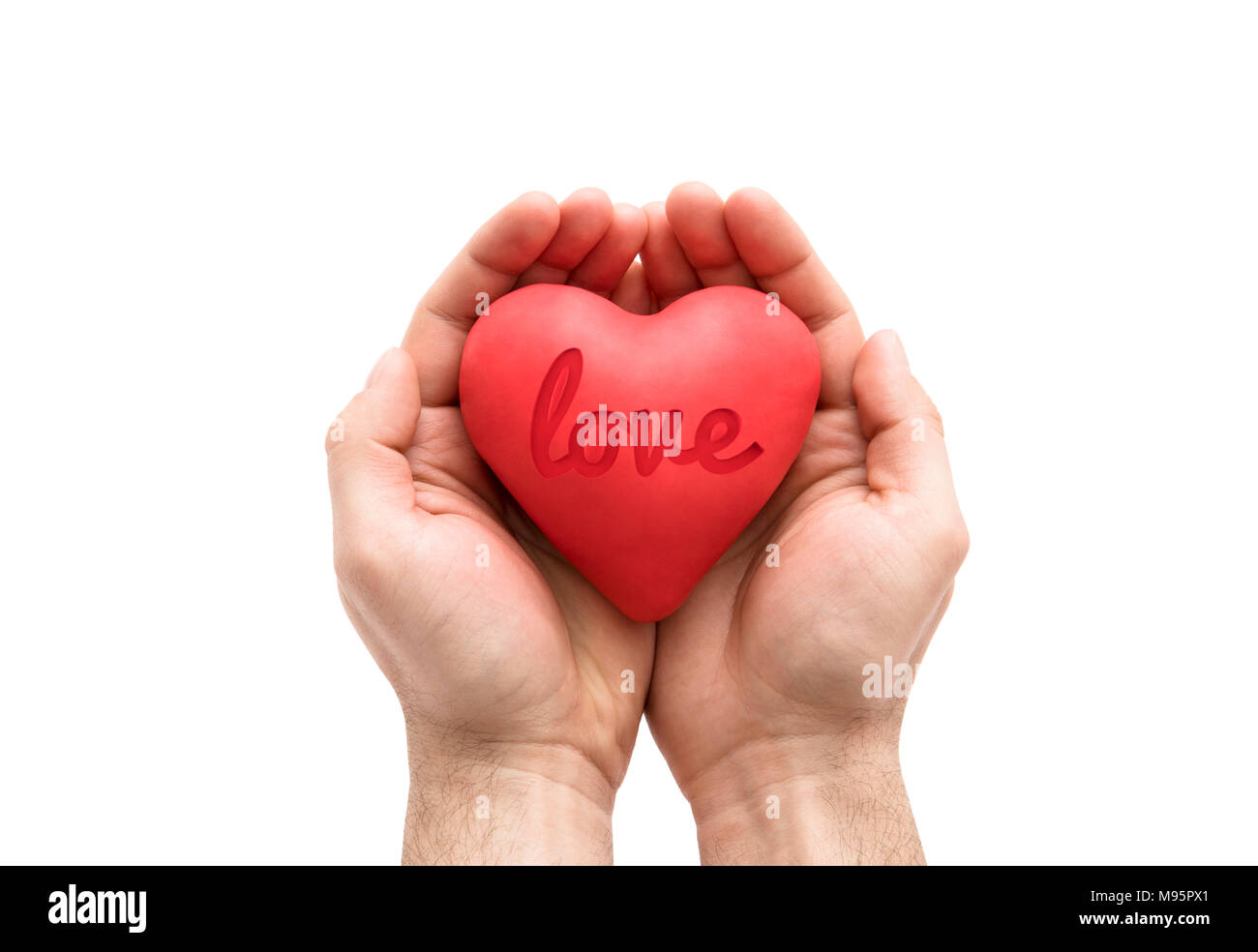 Red heart with imprinted love word in man's hands isolated on white background. Stock Photo