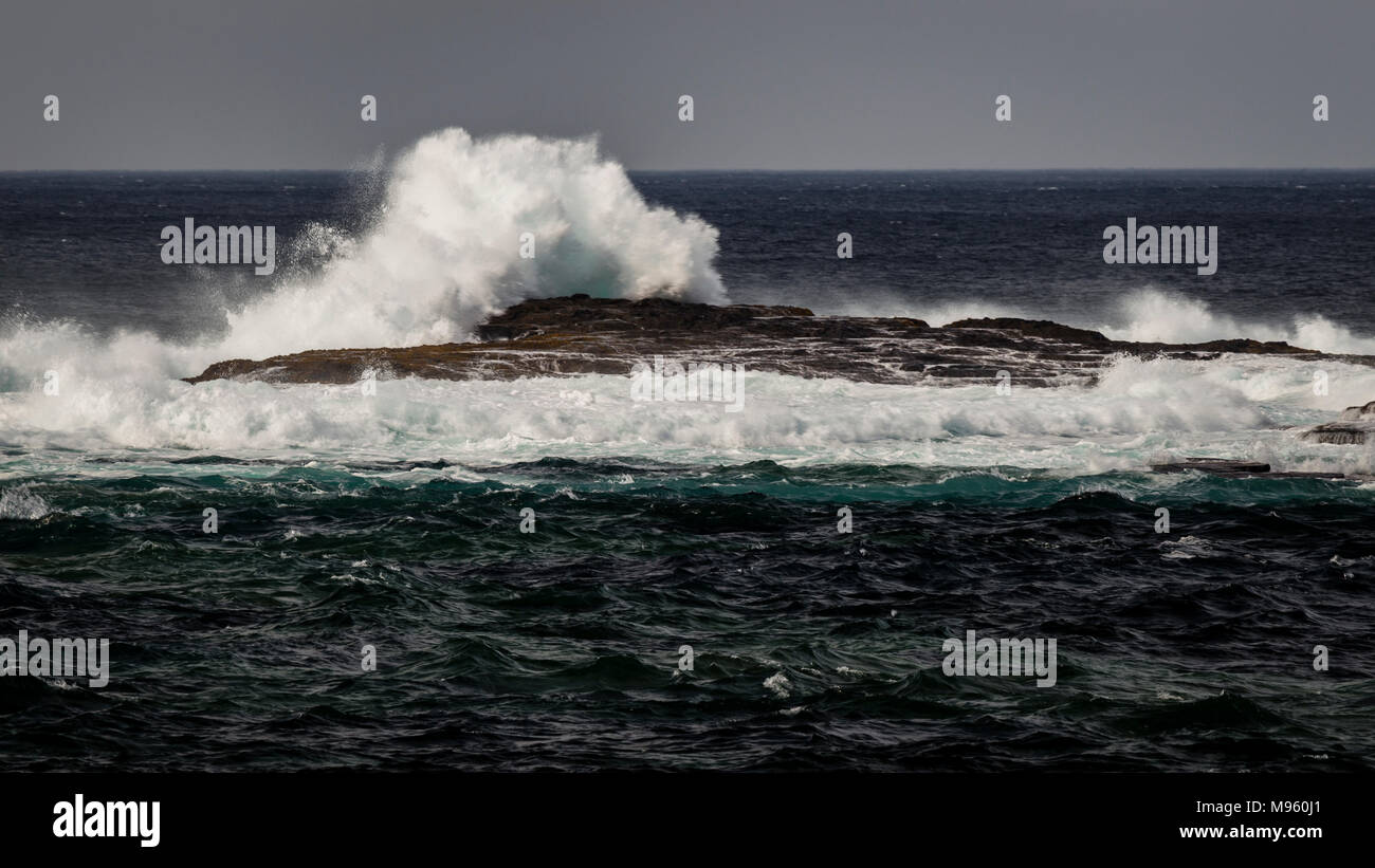 Waves crashing against rocks at Loop Head on Ireland's Atlantic coast in County Clare Stock Photo