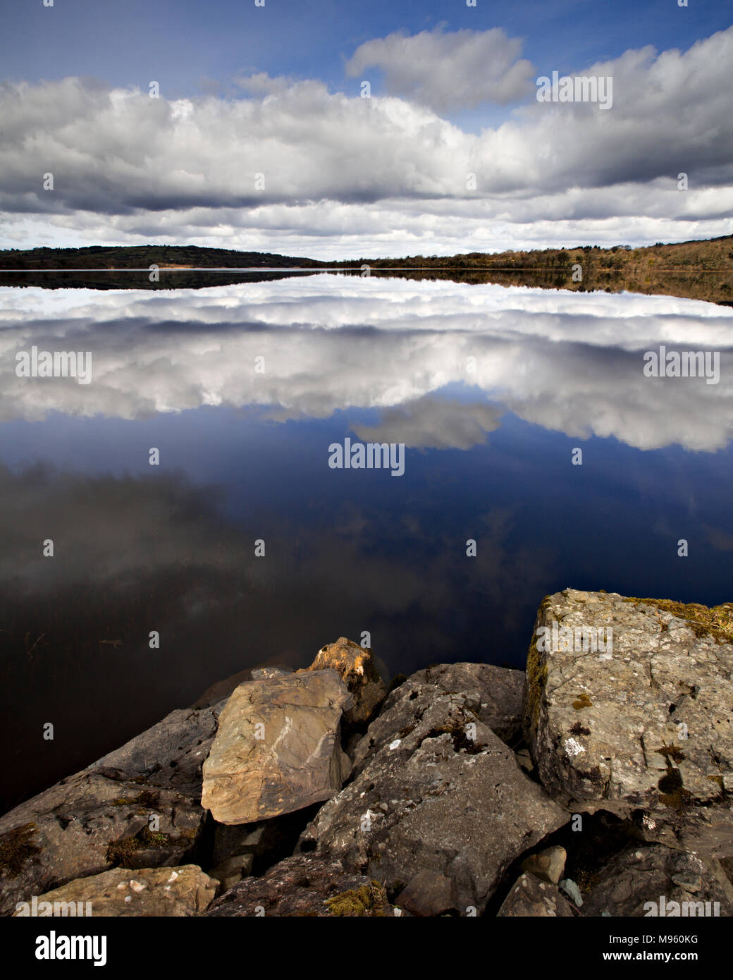 Clouds reflecting in the waters of Lough Graney, County Clare, Ireland on a sunny summer's day Stock Photo