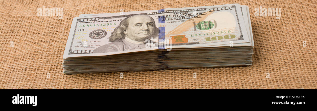 Banknote bundle of US dollar placed on a linen canvas Stock Photo - Alamy