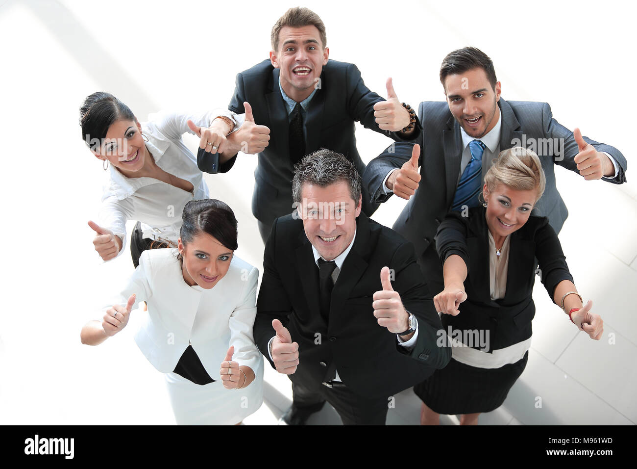 view from the top. happy business team showing thumb up Stock Photo - Alamy