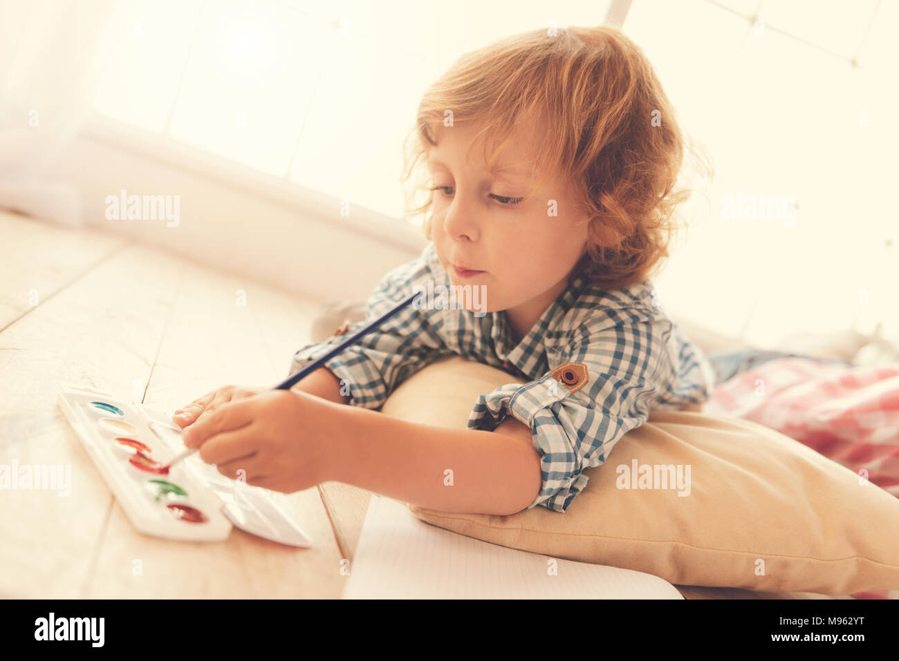 Smart creative boy holding a brush Stock Photo