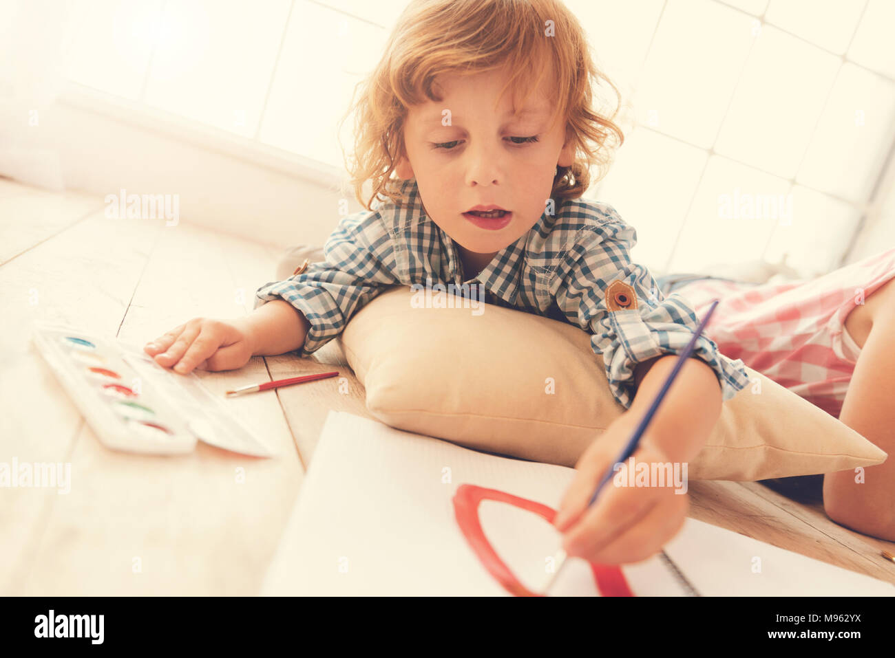 Positive delighted child painting Stock Photo