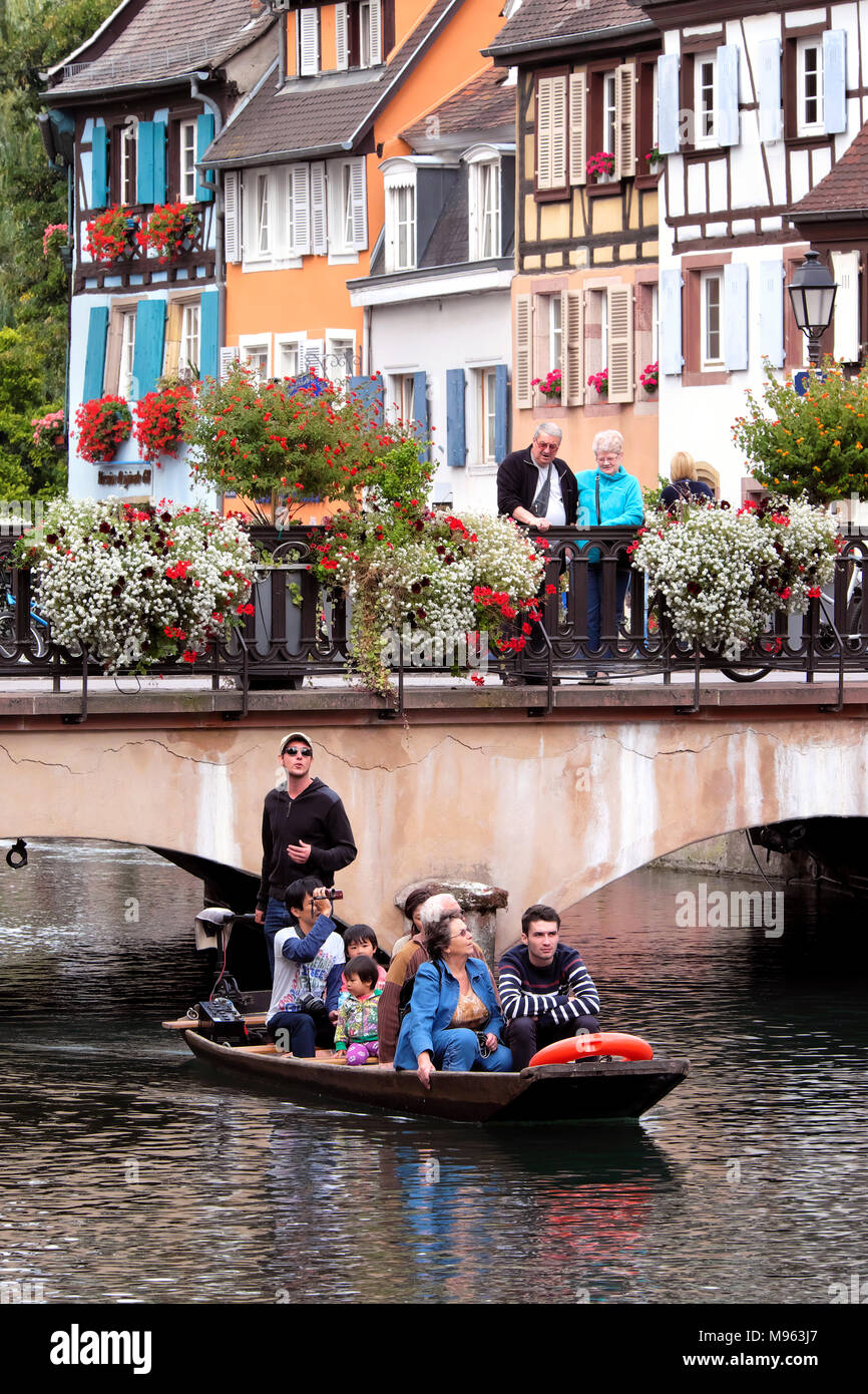 Tourists in river boat on sightseeing trip, Petite Venise / Little Venice, Colmar, Alsace, France Stock Photo