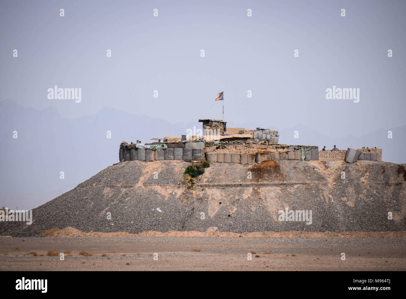 Afghan National Defence and Security Forces' outpost, flying in the Afghan national flag, somewhere close to the main road in Farah province. Afghanistan’s elite military forces – the Commandos and the Special Forces are one of the key elements in the Afghan and U.S. strategy to turn the grinding fight against the Taliban and other insurgents around. These pictures show the Commandos and Special Forces during training and in the field; also right before and after an operation in the restive western Afghan province of Farah. Stock Photo