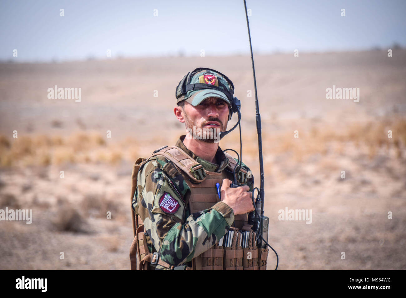 Afghan Commando with radio equipment, somewhere on the main road in Bolo Bluk district, Farah province. Afghanistan’s elite military forces – the Commandos and the Special Forces are one of the key elements in the Afghan and U.S. strategy to turn the grinding fight against the Taliban and other insurgents around. These pictures show the Commandos and Special Forces during training and in the field; also right before and after an operation in the restive western Afghan province of Farah. Stock Photo