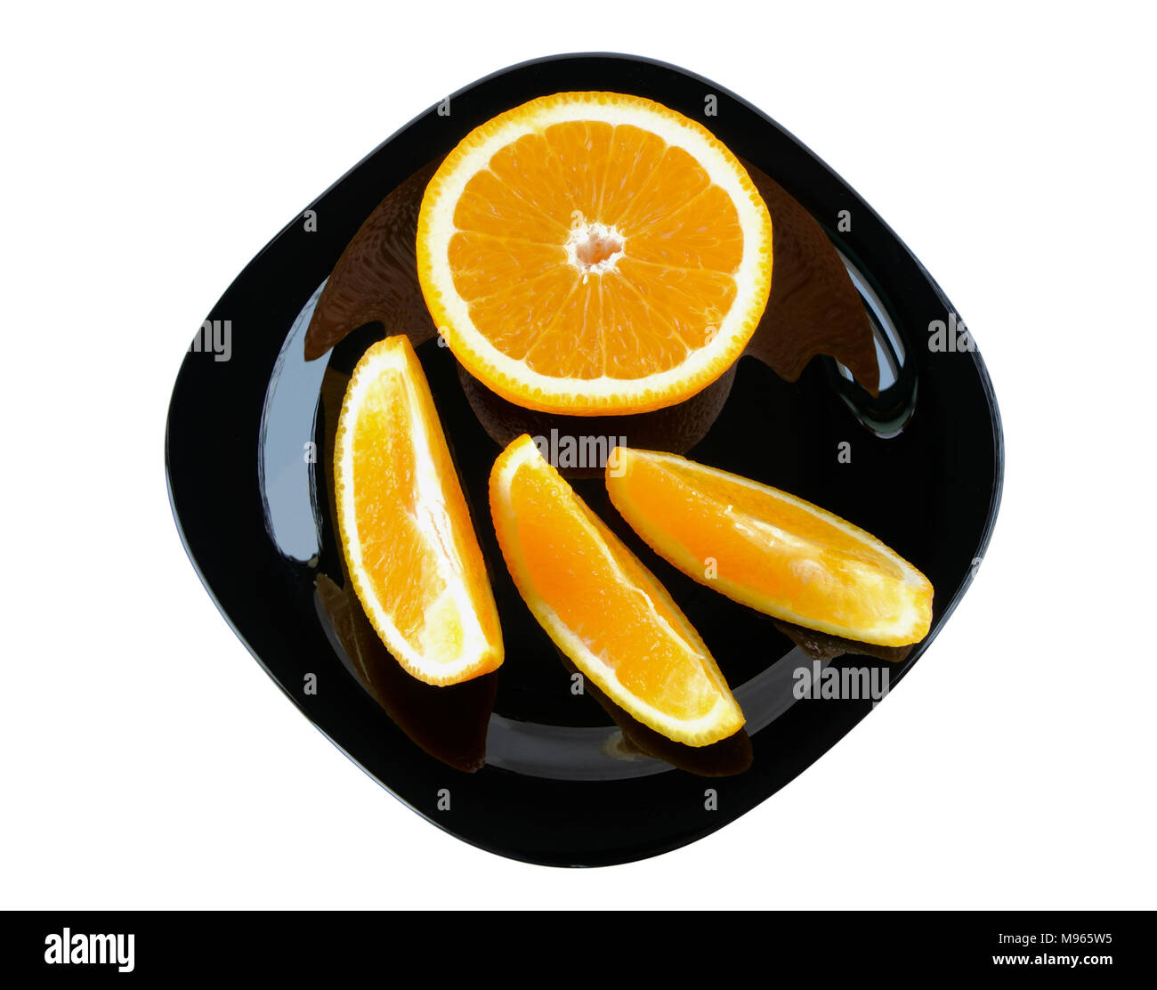Slices of orange on a plate on white background Stock Photo