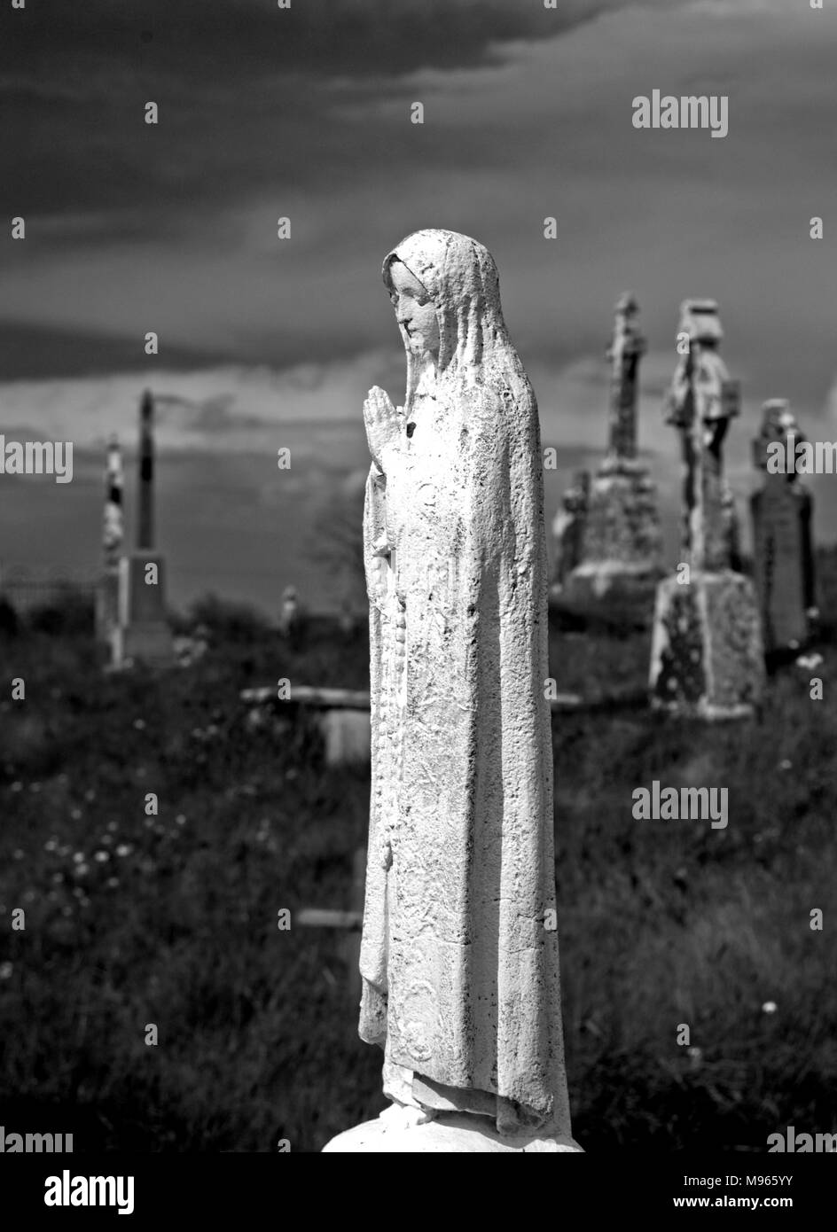 Statue in the graveyard of Turlough Round tower, Knockanour, County Mayo Stock Photo