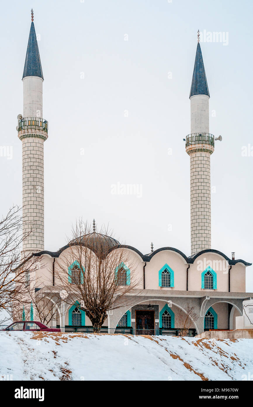 White mosque in snow with twin minarets off road in Todorovo North Western Bosnia in the municipality of Velika Kladusa Stock Photo