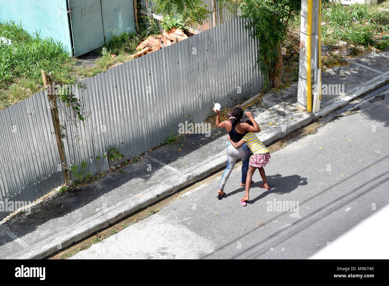 Teenage girls playing on the street in Dominican Republic Stock Photo