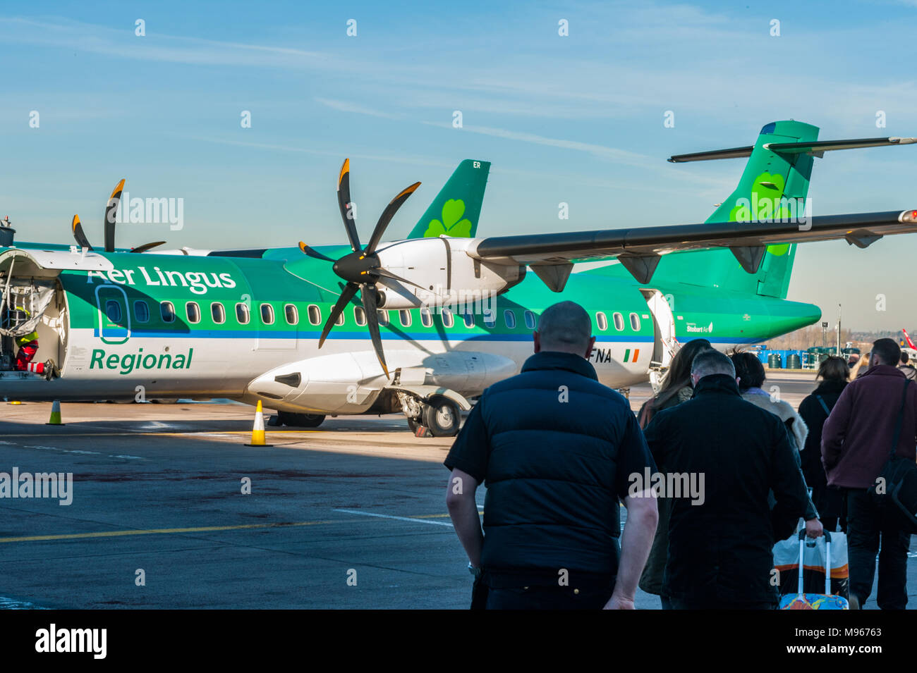 Passengers wait to board an Aer Lingus ATR 72-600 at Birmingham Aiport, UK (BHX) going to Cork, Ireland (ORK) with copy space. Stock Photo