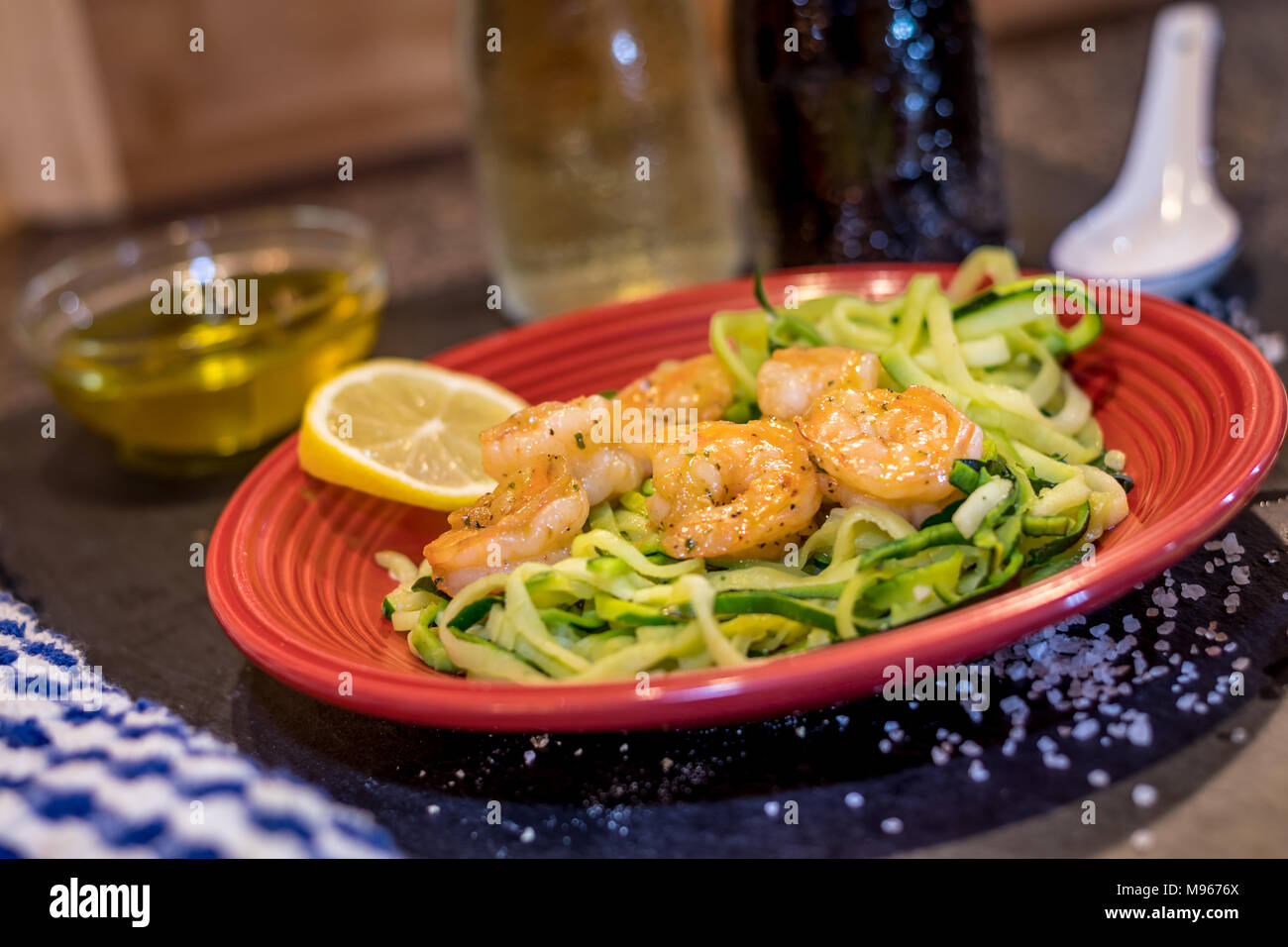 Shrimp Scampi served over zucchini noodles, zoodles, sauteed with lemon, garlic, butter and herbs Stock Photo
